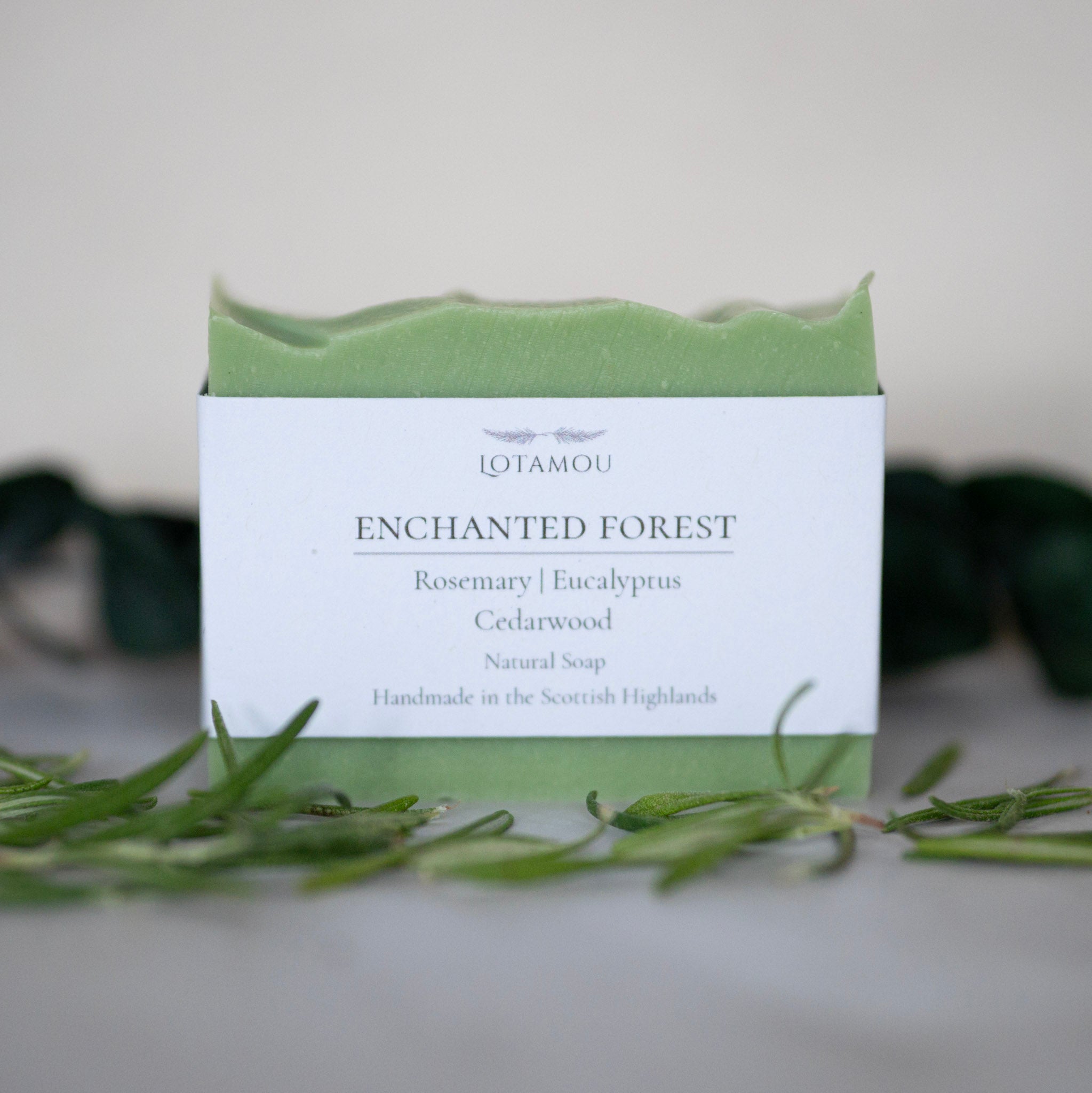 Soap bar with 'Enchanted Forest' packaging on a neutral background