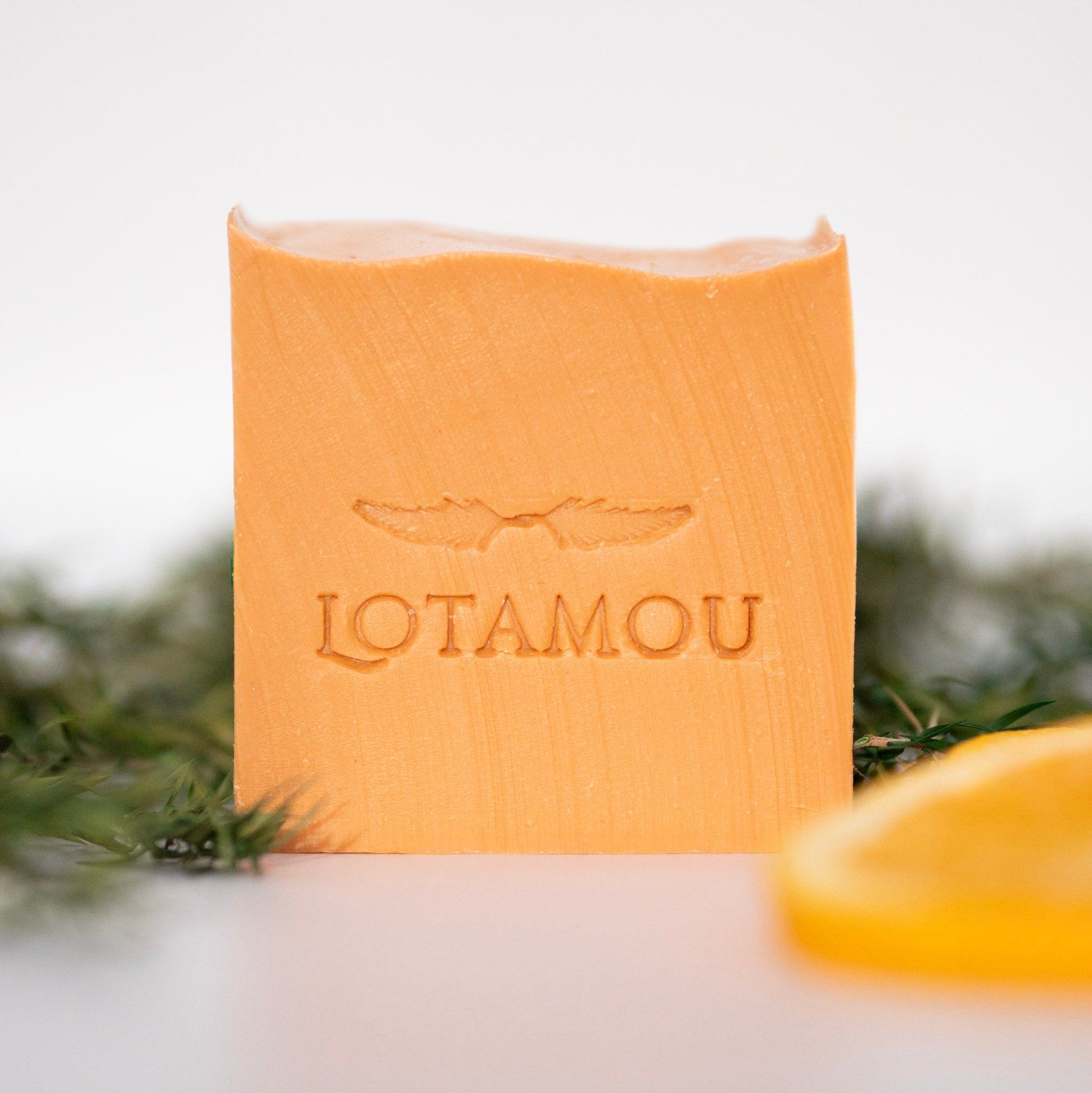 Bar of soap with 'LOTAMOU' branding on a white background
