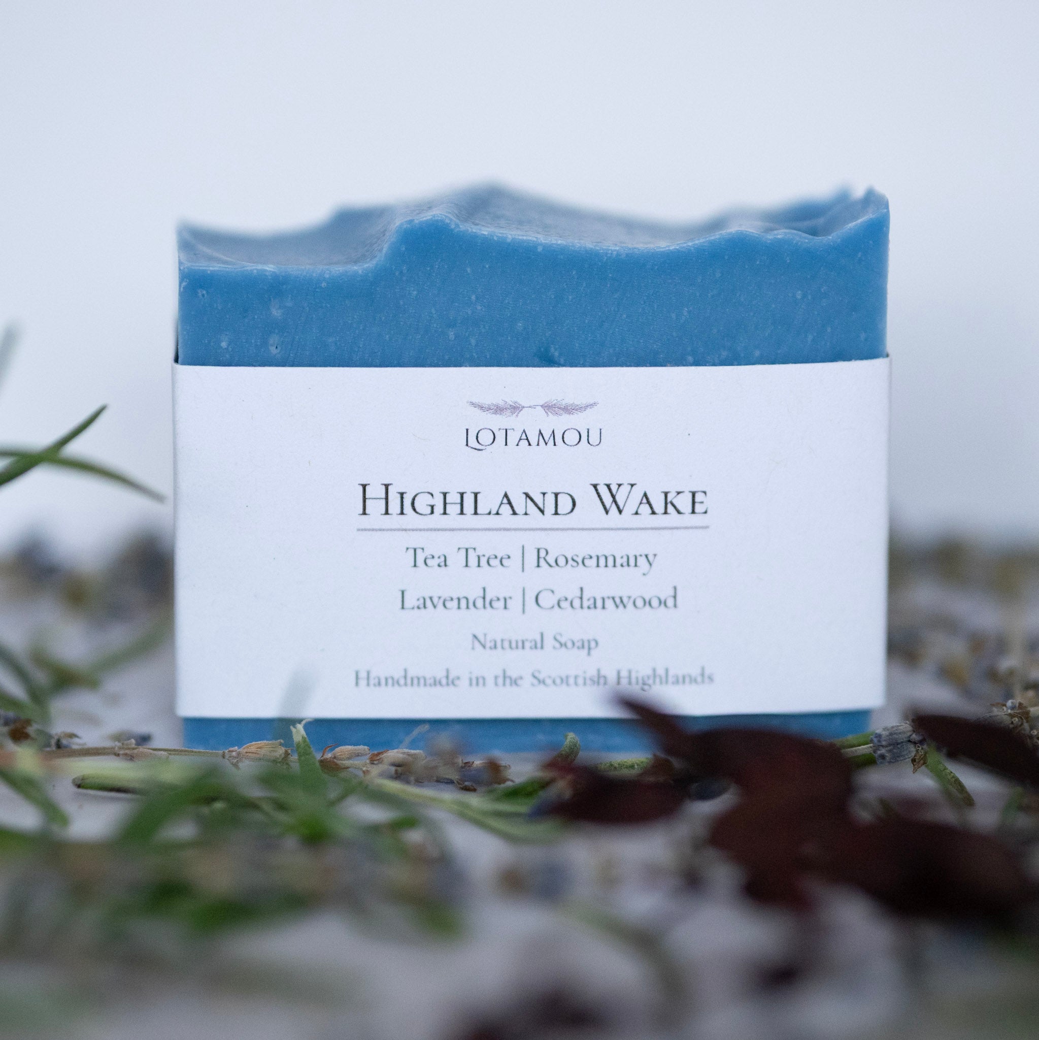 Blue soap bar with a white label on a natural background