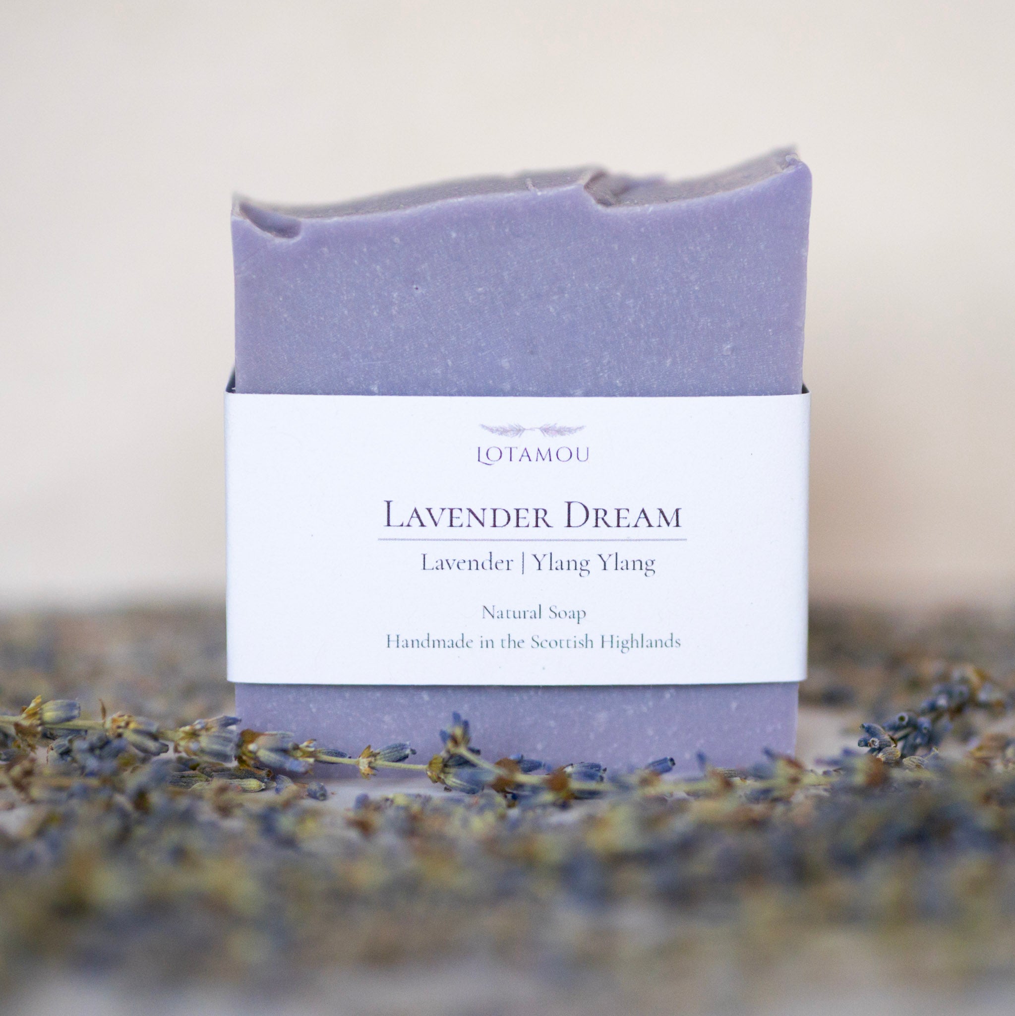 Lavender soap bar with packaging on a blurred background of lavender flowers