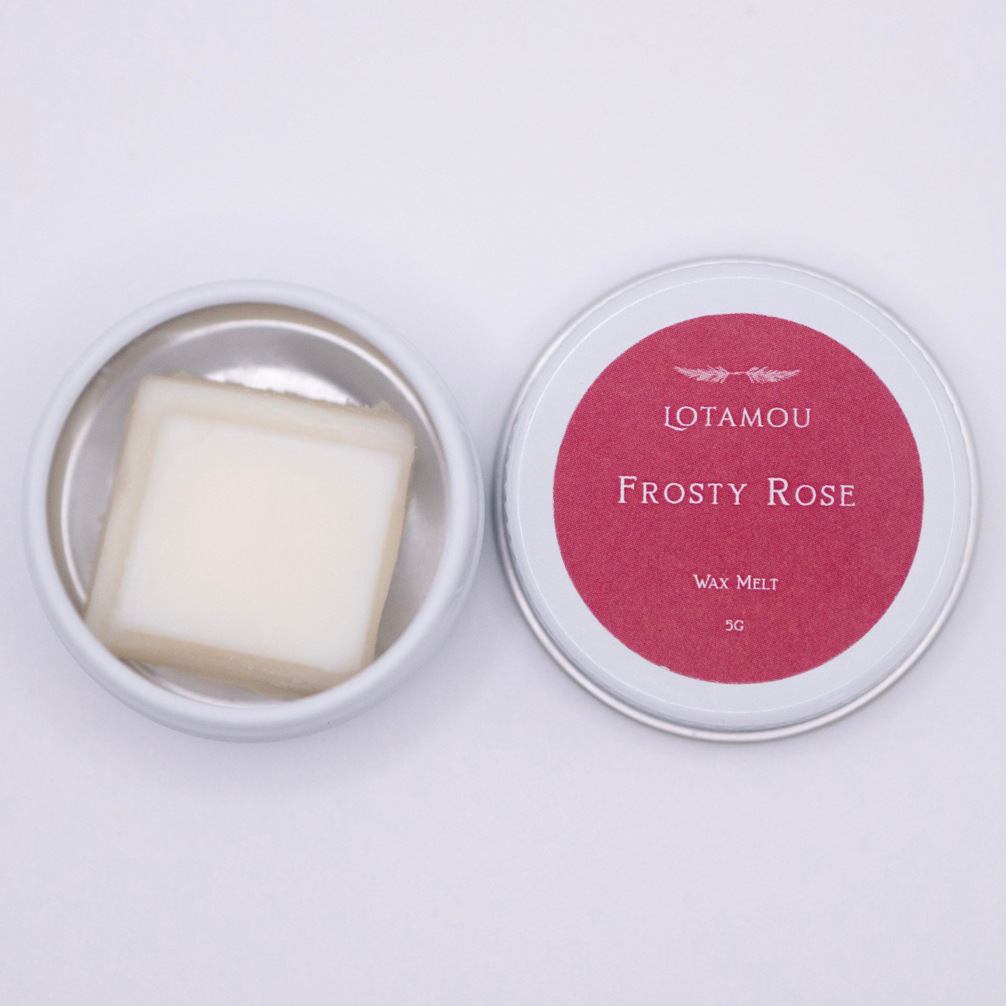Wax melt in a tin with 'LOTAMOU Frosty Rose' label on a white background