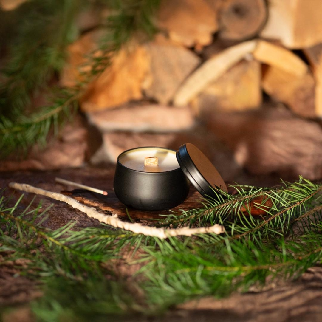 Woody scented candle in a matte black tin with lid. Soy wax candle with wooden wick. 