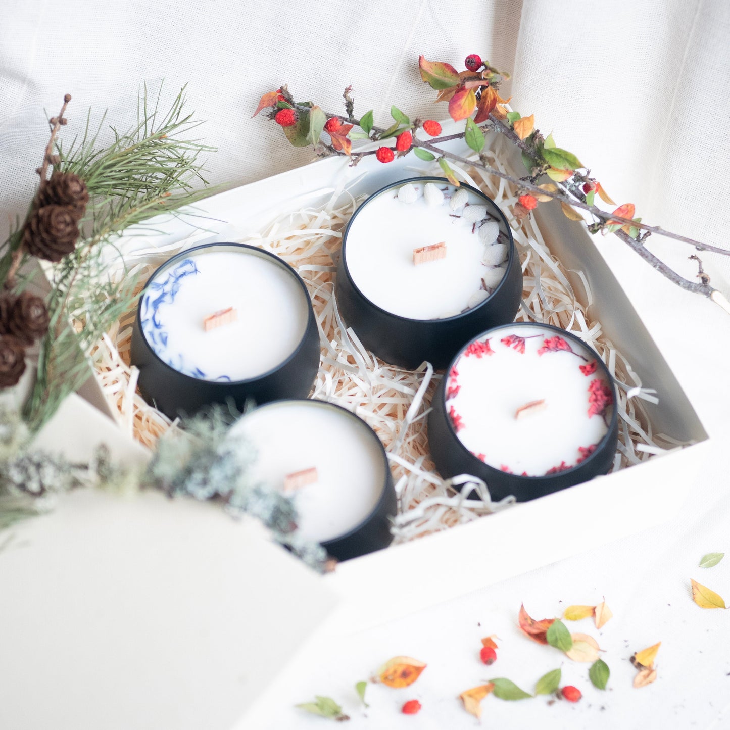 Set of four scented candles in a matte black tins with lids. Hand-poured in the heart of the Scottish Highlands.